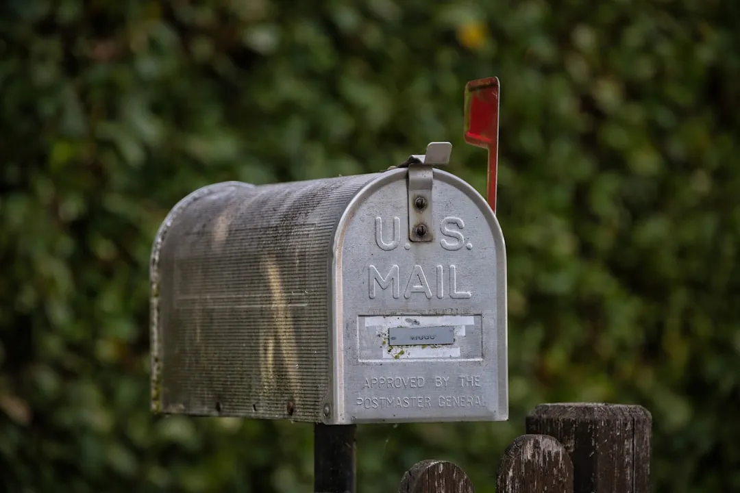 A u.s. mail mailbox stands outdoors.