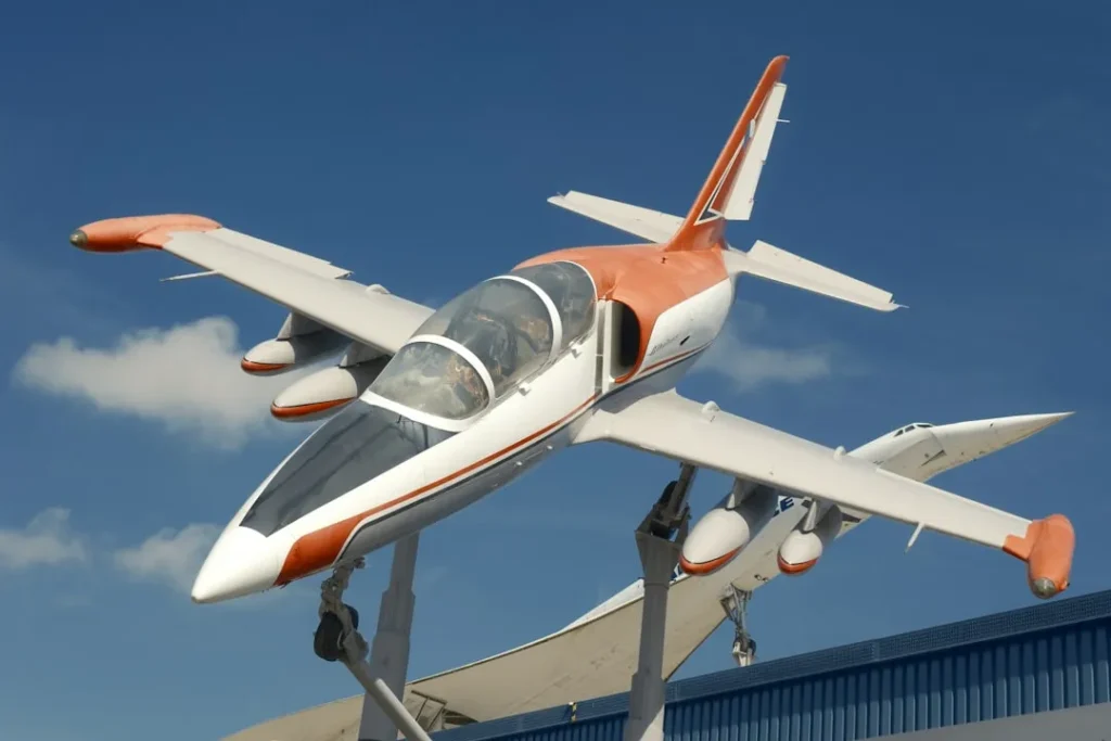 A white and orange airplane on display.