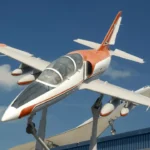 A white and orange airplane on display.