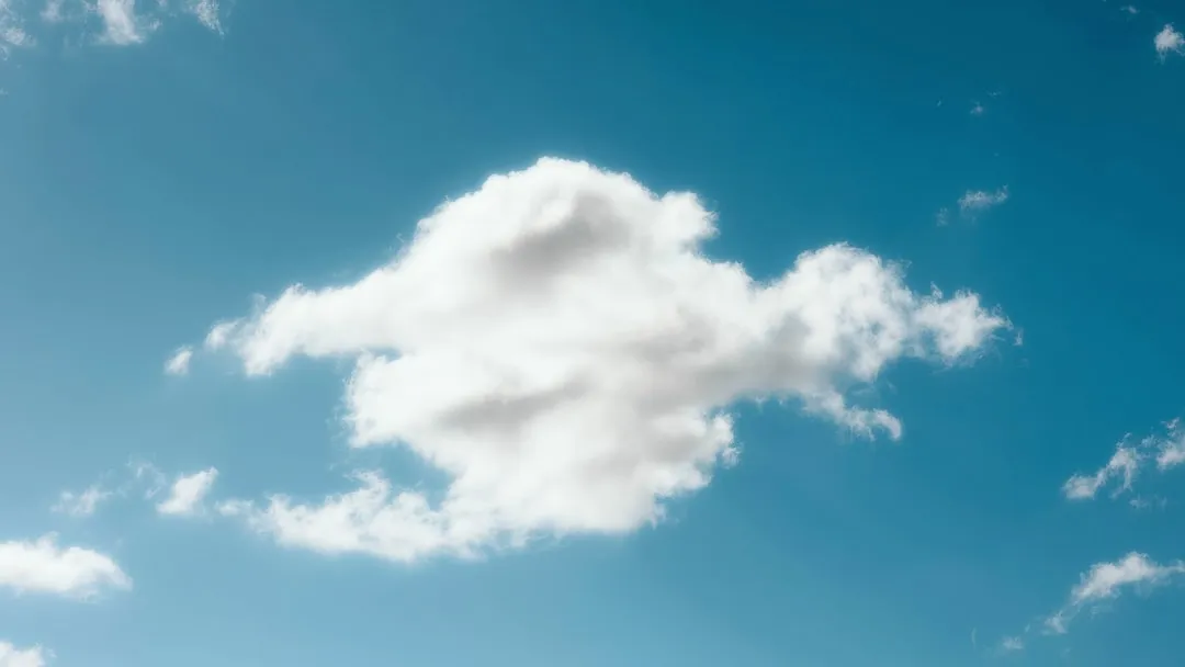 a white cloud in the blue sky