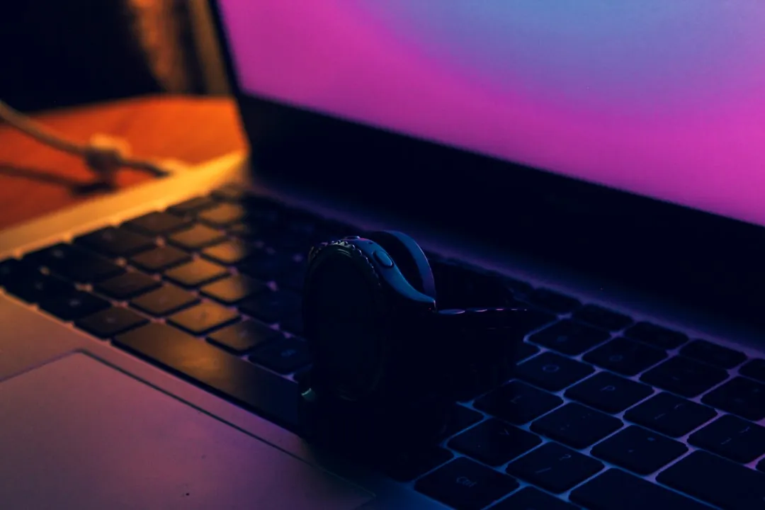 a pair of headphones sitting on top of a laptop keyboard